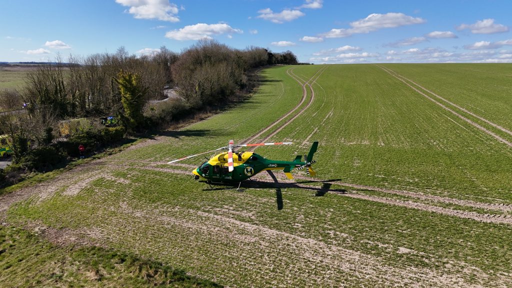 Bell 429 in the corner of a large field